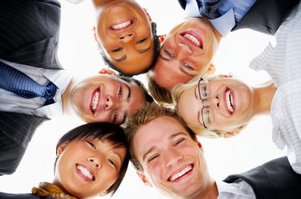 Un gruppo di persone sorridenti disposto in cerchio.
